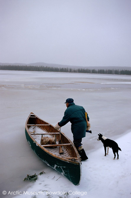 As freeze-up approaches Pinip, an Innu hunter, prepares to go out in his canoe. Labrador, Canada. 1997