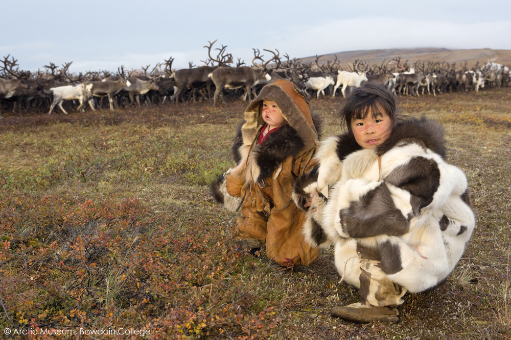 Nadia Takui takes 18 month old Rima Votgyrgina, to watch the reindeer during the Chukchi 'Festival of the Young Reindeer' out on the tundra. Iultinsky District, Chukotka, Siberia, Russia.